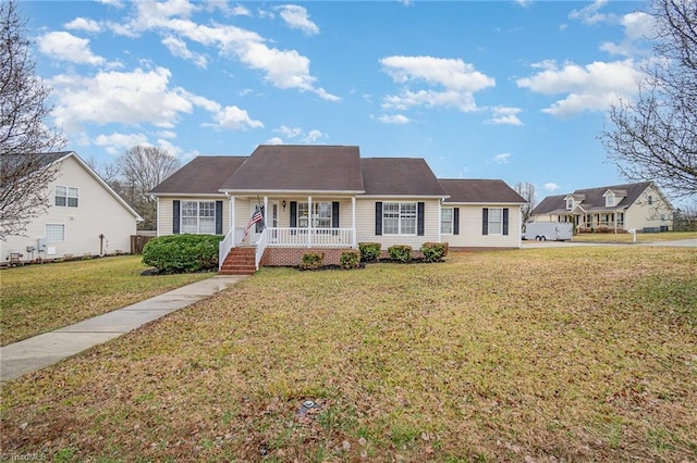 view of front of home with covered porch and a front lawn