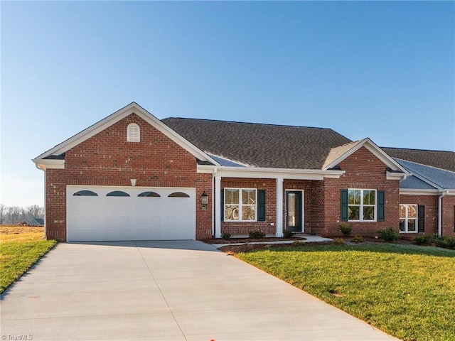 ranch-style house featuring a garage and a front lawn