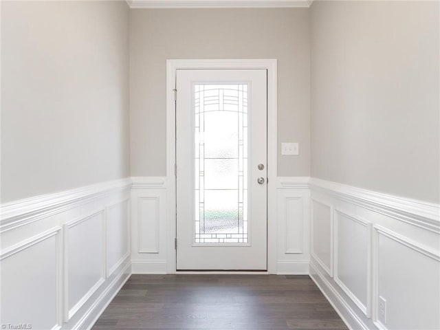 foyer entrance with dark hardwood / wood-style flooring and ornamental molding