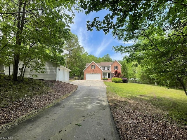 traditional-style home with a front lawn and a garage