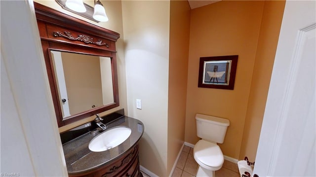 half bath featuring vanity, toilet, and tile patterned flooring
