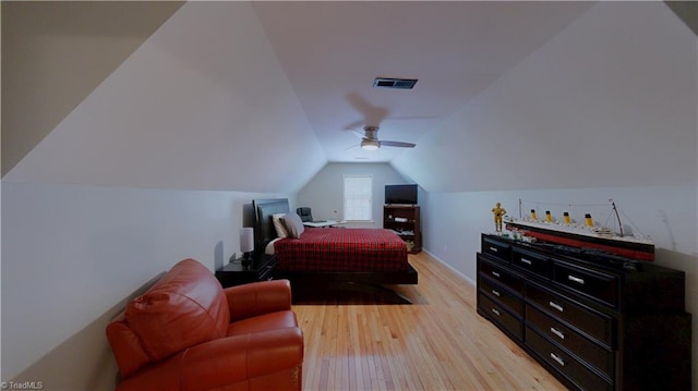 bedroom with light wood-style flooring, visible vents, baseboards, vaulted ceiling, and a ceiling fan