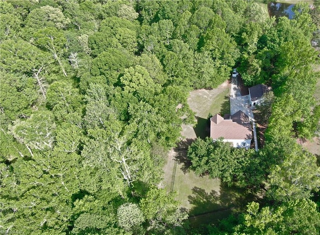 birds eye view of property featuring a wooded view