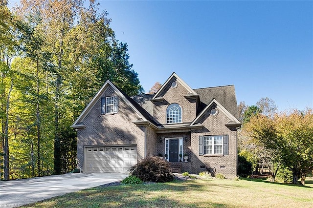 view of front of property with a front yard and a garage