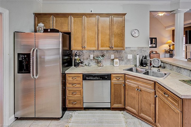 kitchen with sink, decorative columns, crown molding, decorative backsplash, and appliances with stainless steel finishes