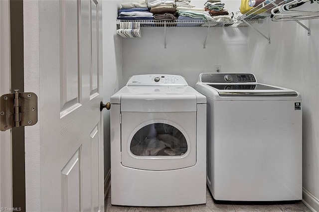 clothes washing area with washing machine and dryer