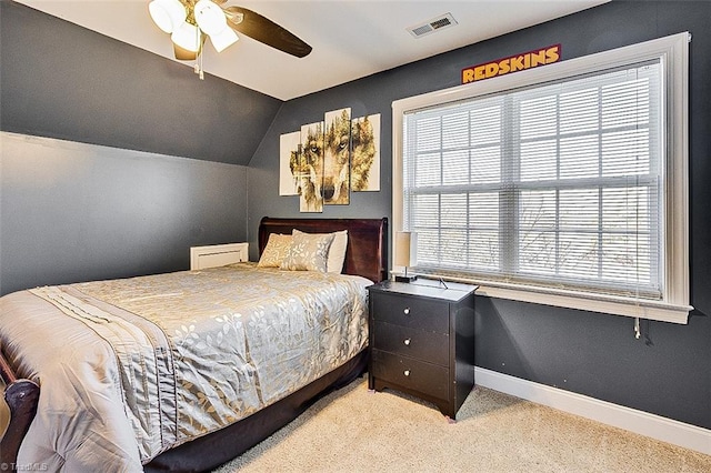 carpeted bedroom with ceiling fan and lofted ceiling