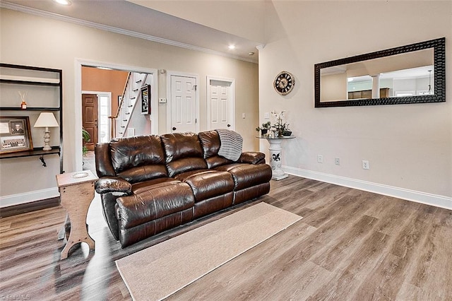 living room with hardwood / wood-style floors and crown molding