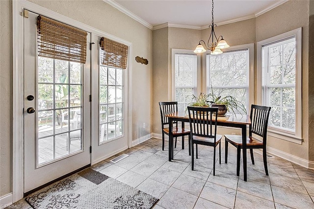 dining space with a wealth of natural light, crown molding, and an inviting chandelier