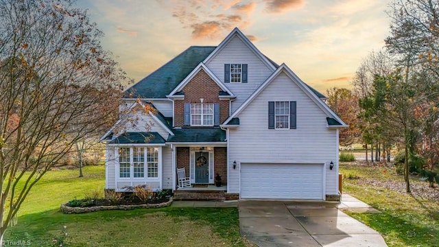 view of front of home featuring a garage and a yard