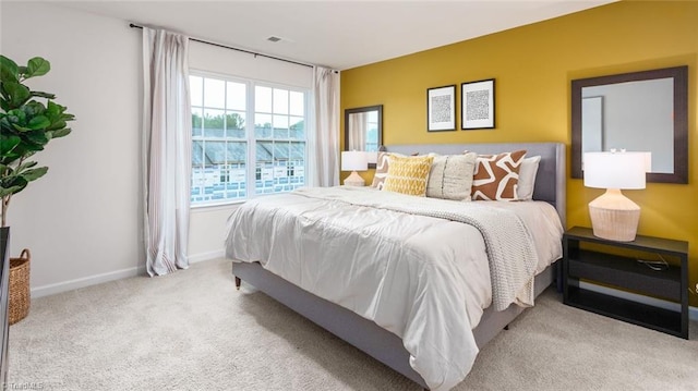 bedroom featuring light colored carpet