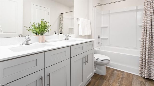 full bathroom with toilet, wood-type flooring, shower / bathtub combination with curtain, and vanity