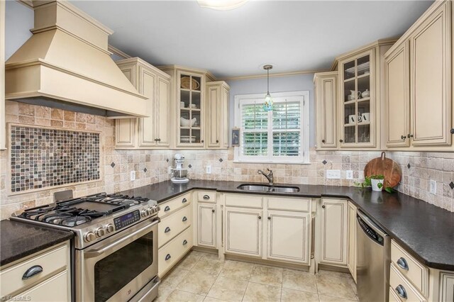 kitchen featuring appliances with stainless steel finishes, backsplash, sink, and custom range hood