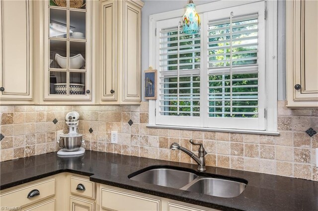 kitchen featuring cream cabinetry, sink, tasteful backsplash, and plenty of natural light