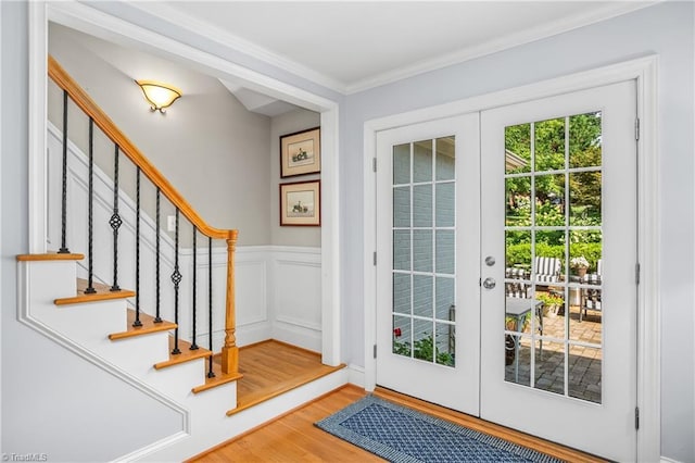 entryway featuring french doors, ornamental molding, and hardwood / wood-style floors