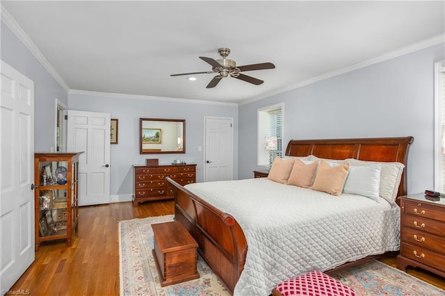 bedroom featuring ceiling fan, wood-type flooring, and ornamental molding