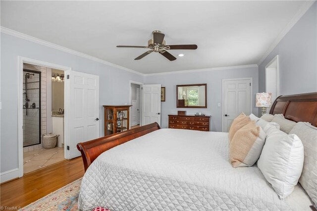 bedroom with connected bathroom, light wood-type flooring, and crown molding