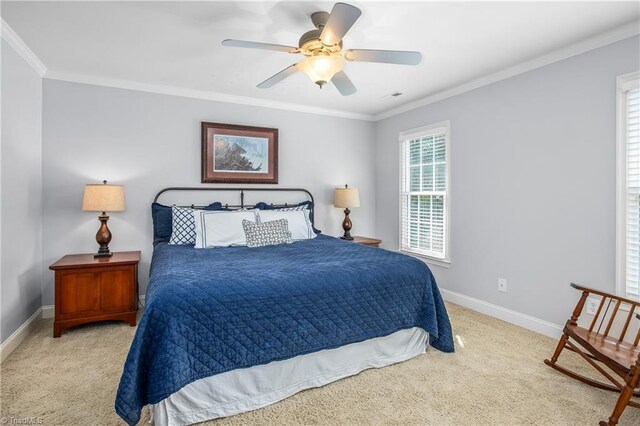 carpeted bedroom with ceiling fan and crown molding