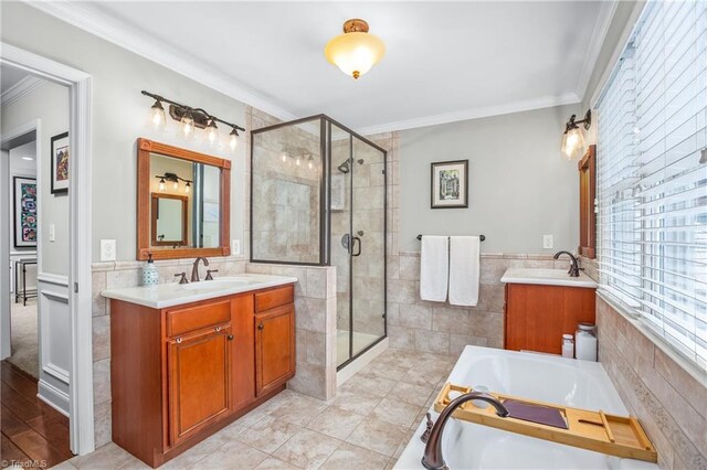 bathroom with tile walls, ornamental molding, tile patterned flooring, and separate shower and tub