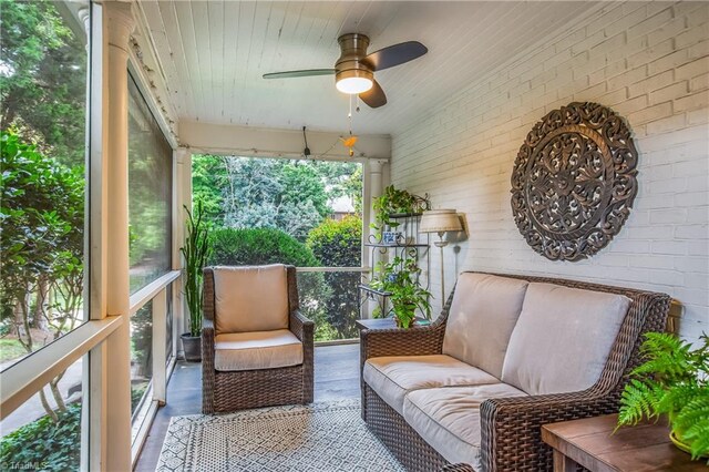 sunroom featuring ceiling fan