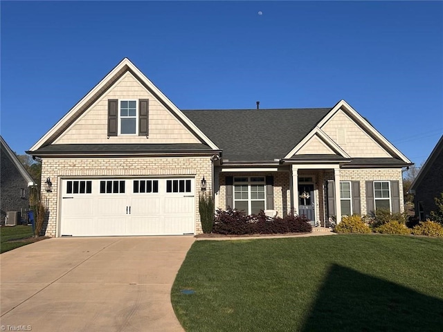 craftsman-style home with a front yard, brick siding, a garage, and concrete driveway