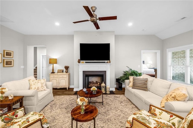 living room with vaulted ceiling, recessed lighting, a ceiling fan, wood finished floors, and a fireplace