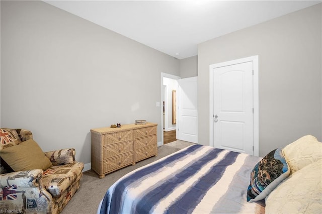 carpeted bedroom featuring baseboards