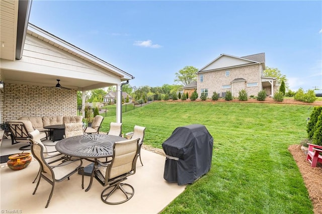 view of yard with a patio area, a ceiling fan, and an outdoor living space