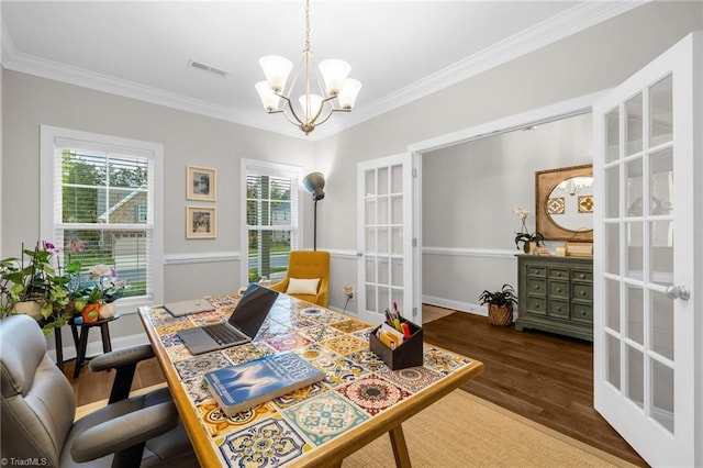 dining area featuring plenty of natural light, wood finished floors, visible vents, french doors, and a chandelier