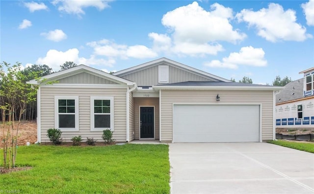 single story home featuring a garage, board and batten siding, concrete driveway, and a front yard