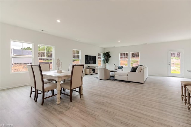 dining area featuring recessed lighting, light wood-type flooring, and baseboards