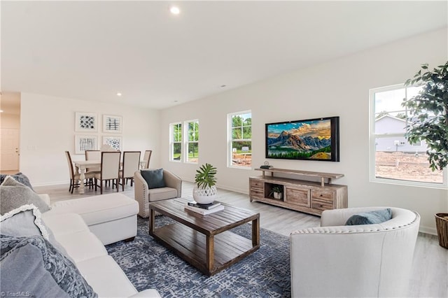 living room featuring recessed lighting, baseboards, and wood finished floors