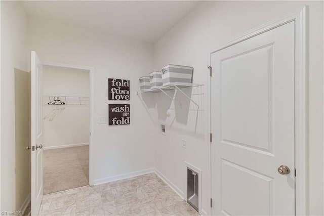 washroom with baseboards, hookup for a washing machine, and laundry area