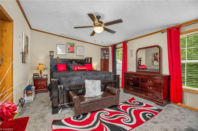 bedroom featuring ceiling fan, light colored carpet, a textured ceiling, and multiple windows