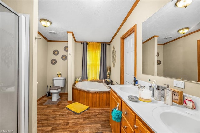 full bathroom with vanity, a textured ceiling, crown molding, hardwood / wood-style flooring, and toilet