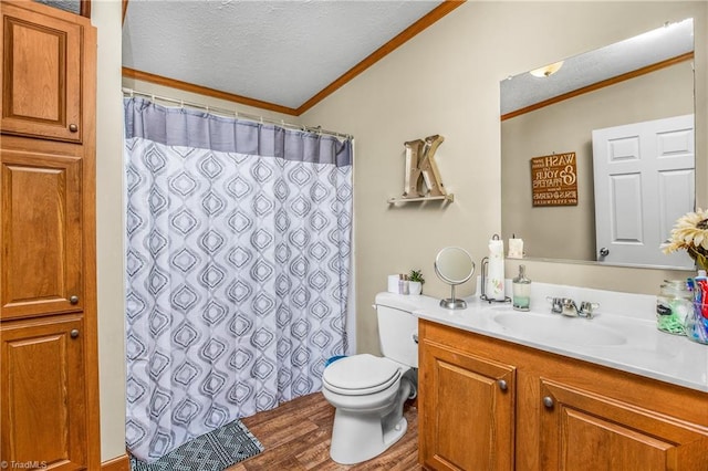 bathroom featuring vanity, toilet, ornamental molding, a textured ceiling, and wood-type flooring