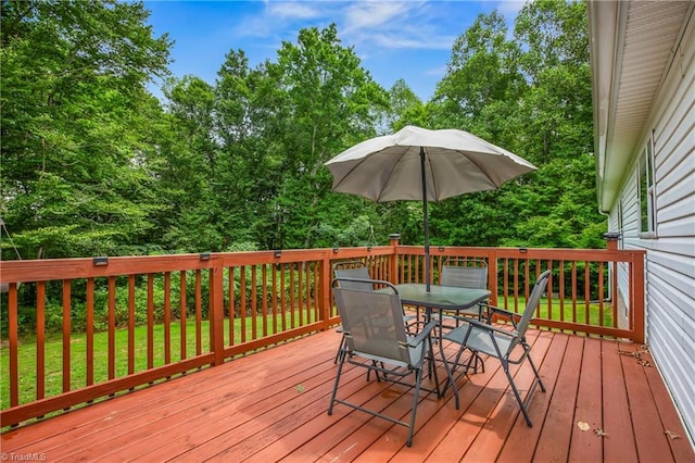 wooden terrace featuring a lawn