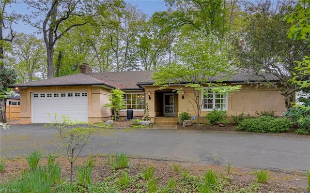 2555 Country Club Rd, Winston-Salem, NC 27104 - ranch-style house featuring stucco siding, driveway, a chimney, and a garage