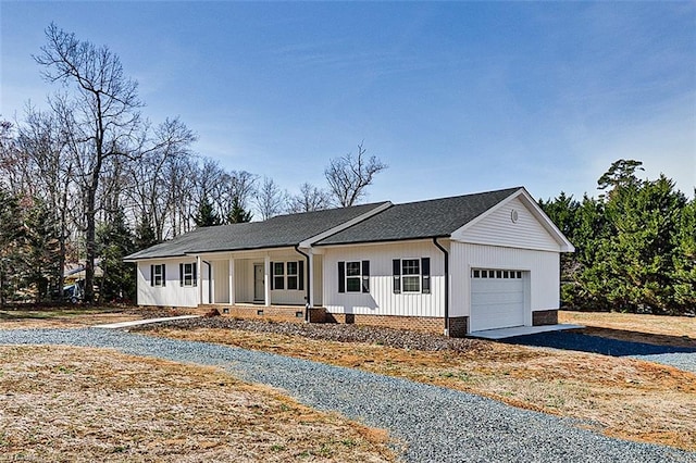 view of front facade with covered porch, aphalt driveway, and an attached garage