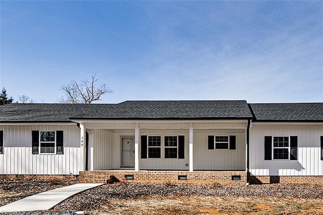 view of front facade with crawl space and a shingled roof