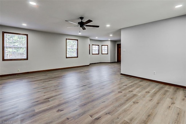 spare room with recessed lighting, baseboards, and light wood finished floors