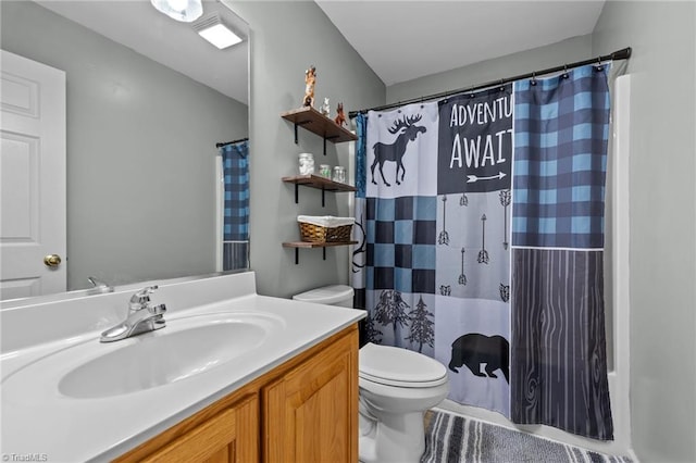 bathroom with vanity, curtained shower, and toilet