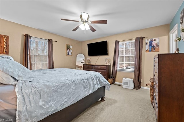 bedroom with baseboards, light colored carpet, and a ceiling fan