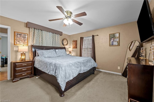 bedroom featuring baseboards, light carpet, and ceiling fan