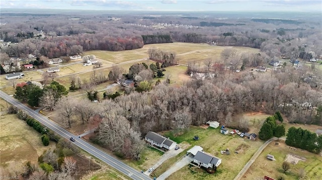 drone / aerial view featuring a rural view and a wooded view