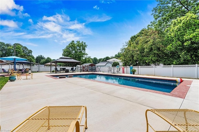 view of swimming pool with a gazebo, a patio, and fence