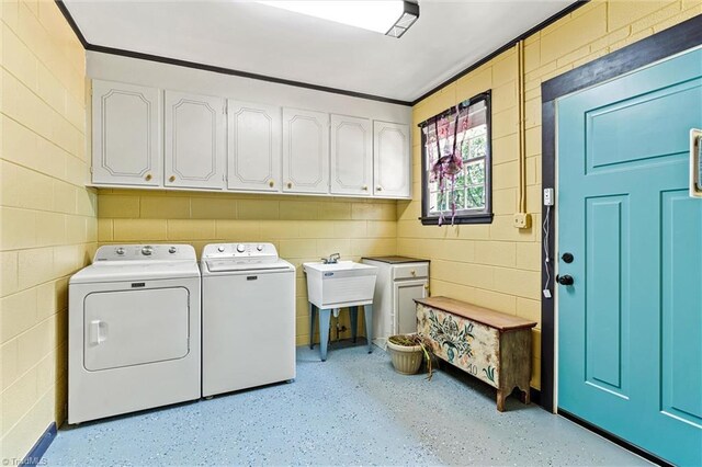 laundry area with cabinet space and independent washer and dryer