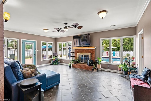 living area featuring tile patterned flooring, a fireplace, plenty of natural light, and crown molding