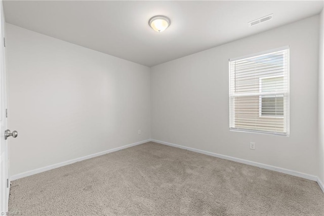 unfurnished room with light carpet, baseboards, and visible vents