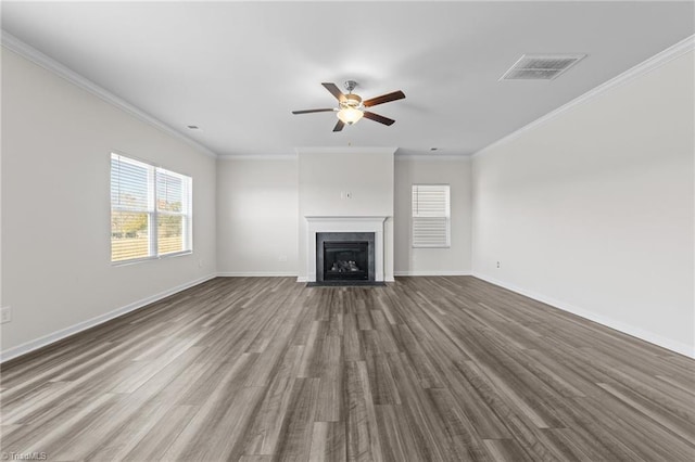 unfurnished living room featuring a fireplace with flush hearth, visible vents, baseboards, and wood finished floors